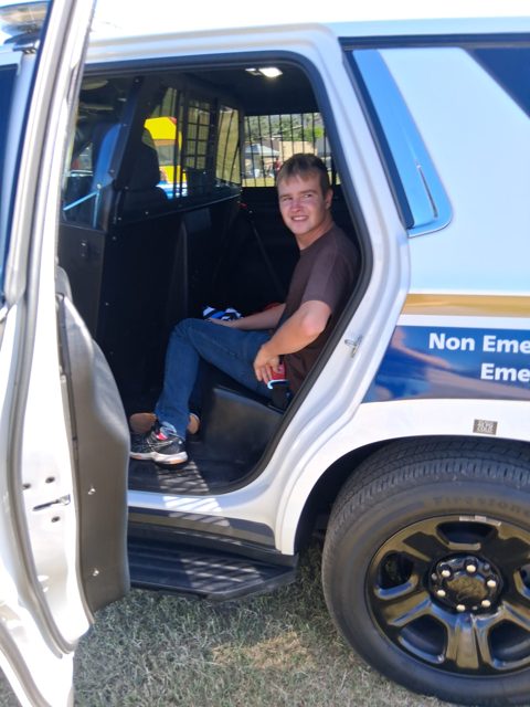 Trying the seat of a display vehicle