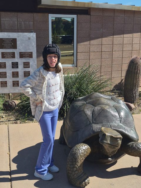 Posing beside an animal sculpture