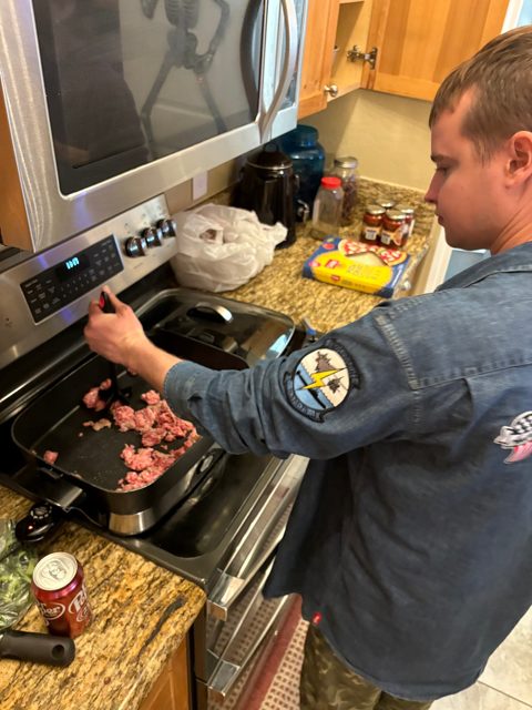 Helping cook at the stove